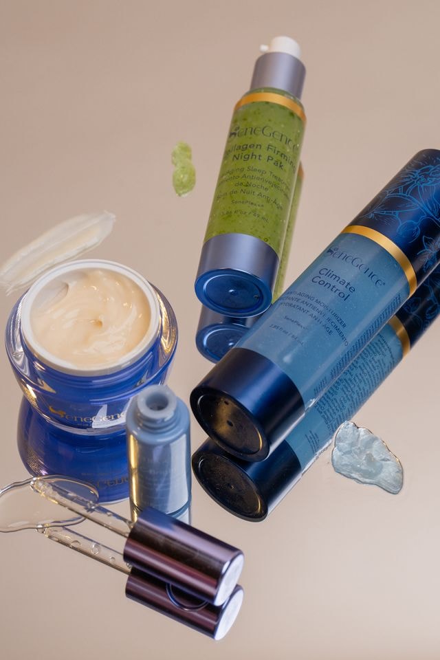 SeneGence skincare bottles and jars arranged on a reflective surface